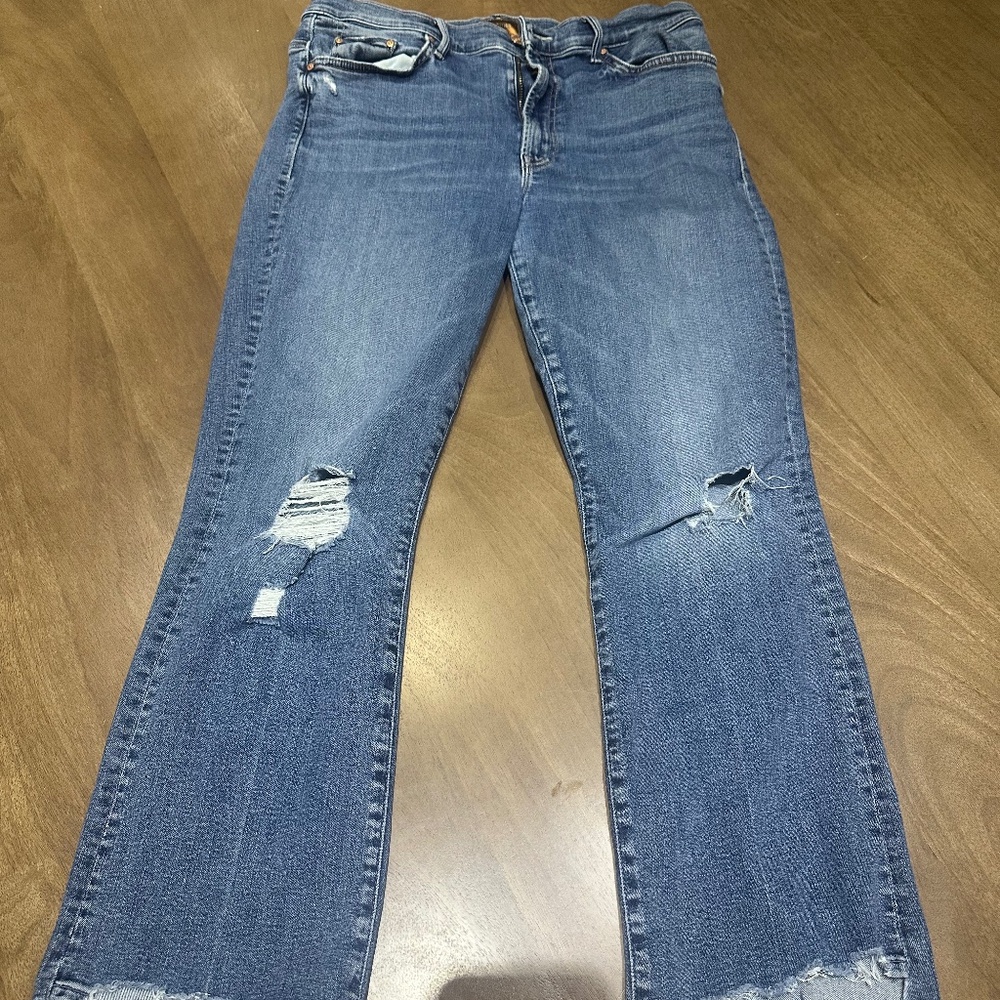 Mother dark washed slightly ripped jeans.